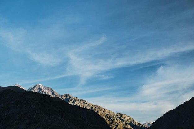 Morning in the mountains the sun illuminates the peaks of the rocks early autumn a view of the Caucasus mountains Banner with space for text trip to Georgia trekking in the mountains