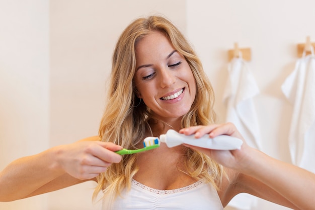 Morning routine by brushing teeth in bathroom