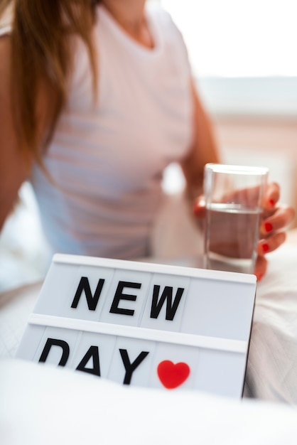 Free photo morning woman holding a glass of water