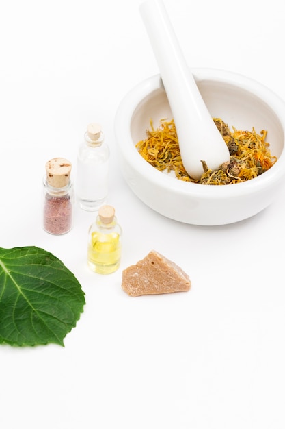 Free photo mortar and pestle and essential oil bottles for natural medicine