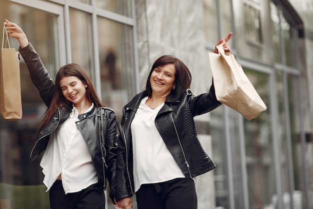 Mother and adult daughter with shopping bag