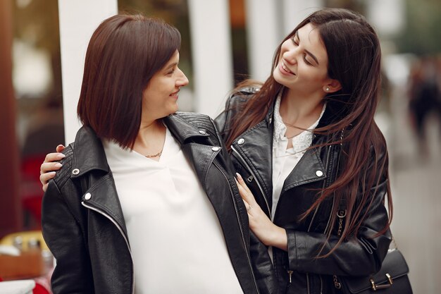 Mother and adult daughter with shopping bag