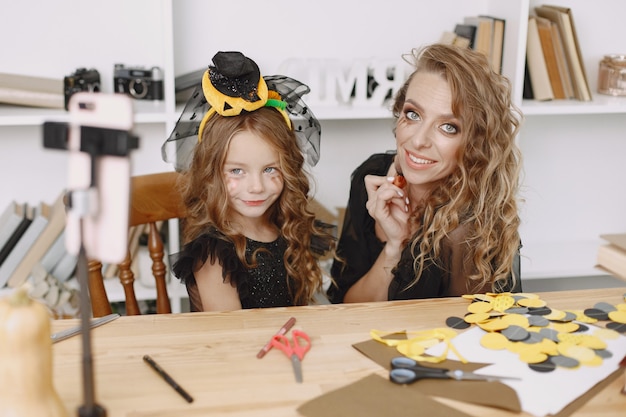 Free photo mother applying halloween make up