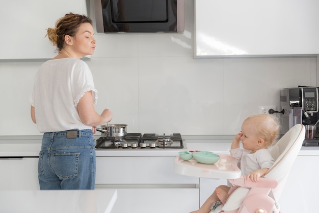 Mother and baby girl together in the kitchen