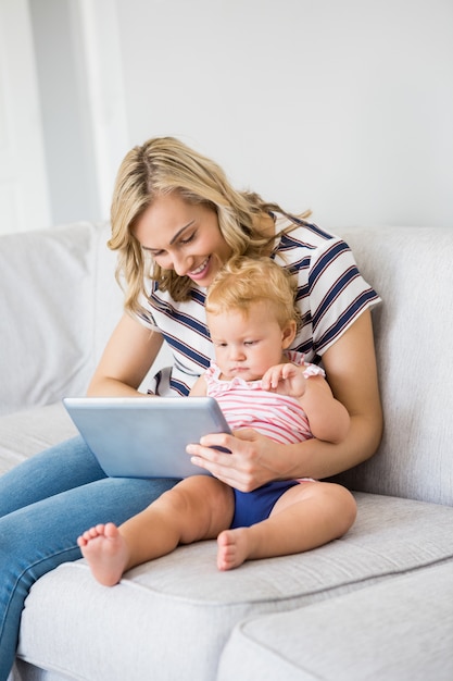 Mother and baby girl using digital tablet