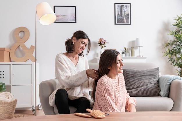 Mother braiding her daughter hair