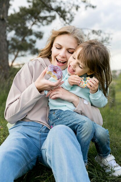 Mother and child eating doughnuts