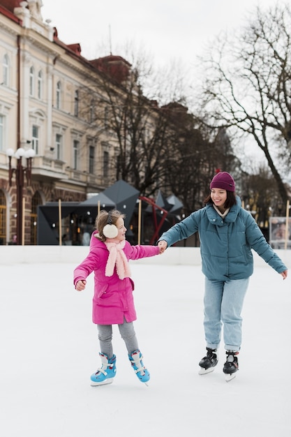 Mother and child ice skating together