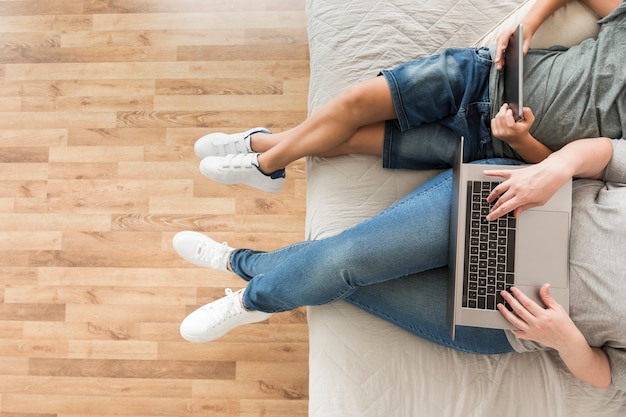 Mother and child looking on smart devices