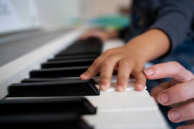 Mother and child playing piano