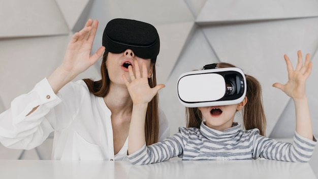 Mother and child using virtual reality headset and being amazed