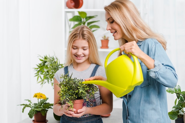 Mother and child watering flowers