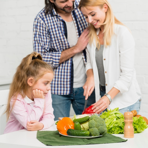 Mother cutting vegetables