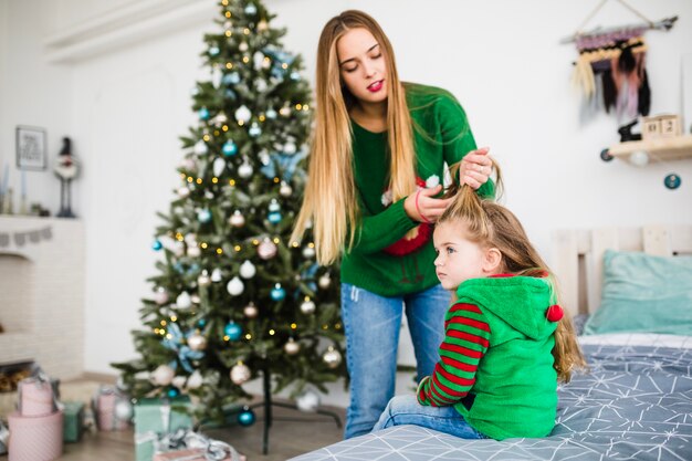 Mother and daughter on bed at christmas