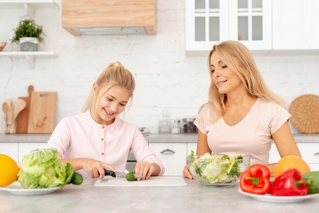 Mother and daughter cooking together