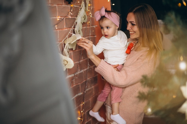 Mother and daughter decorating home on Christmas