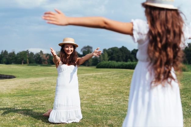 Mother and daughter embracing outdoors