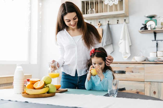 Mother and daughter having breakfast