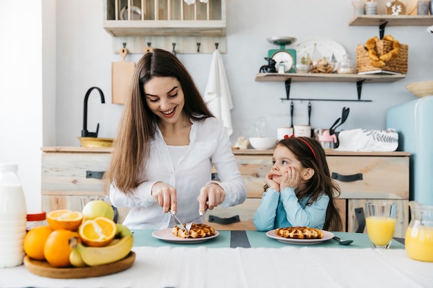 Mother and daughter having breakfast