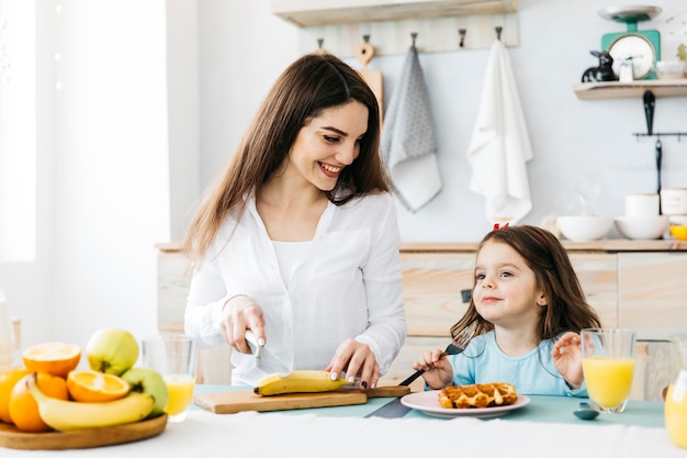 Mother and daughter having breakfast