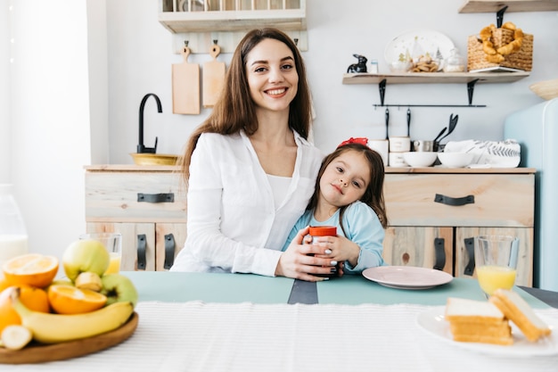 Mother and daughter having breakfast