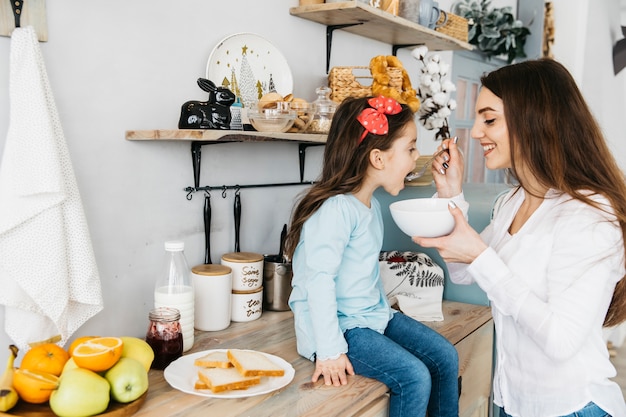 Mother and daughter having breakfast