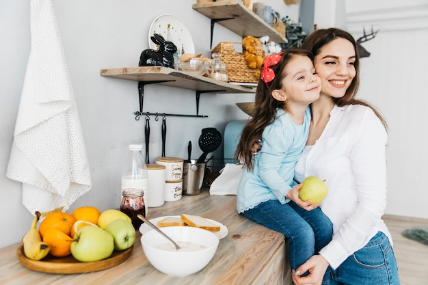 Mother and daughter having breakfast