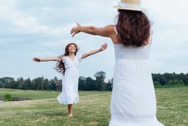 Mother and daughter having fun by the lake