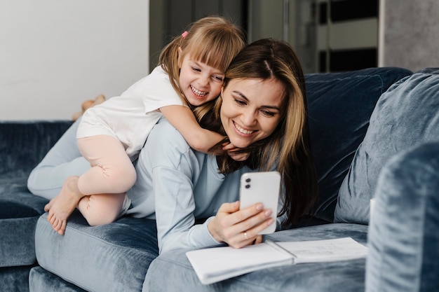 Mother at daughter at home taking a self photo