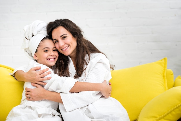 Mother and daughter hugging in robes