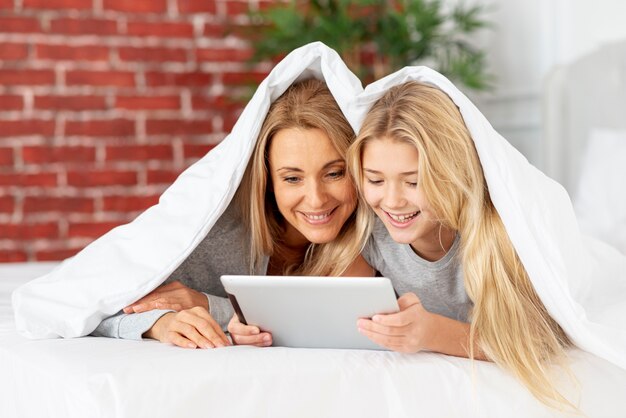 Mother and daughter looking on tablet