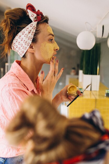 Mother and daughter making masks home