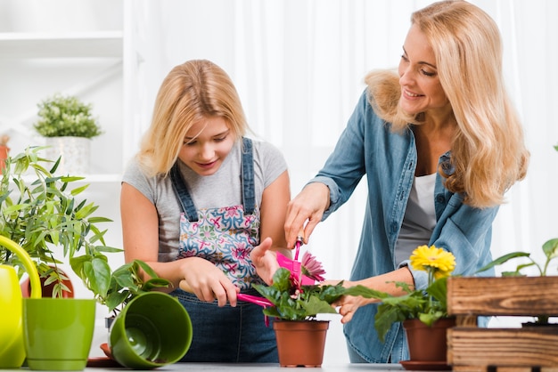 Free photo mother and daughter planting flower