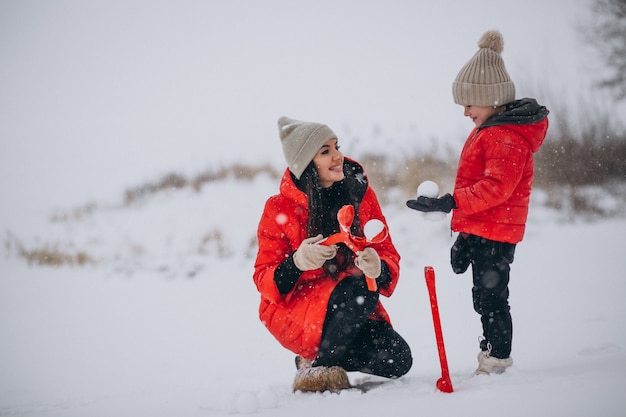 Mother and daughter playing in winter park