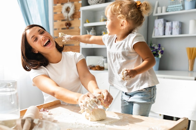 Mother and daughter playing with dough