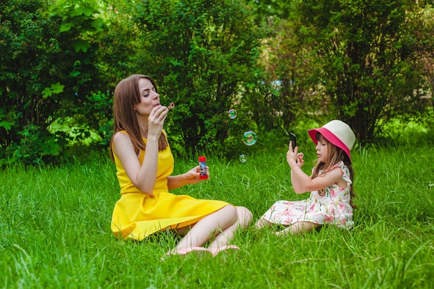 Mother and daughter playing with soap bubbles