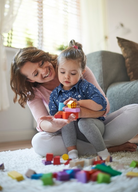 Mother and daughter playing with toys