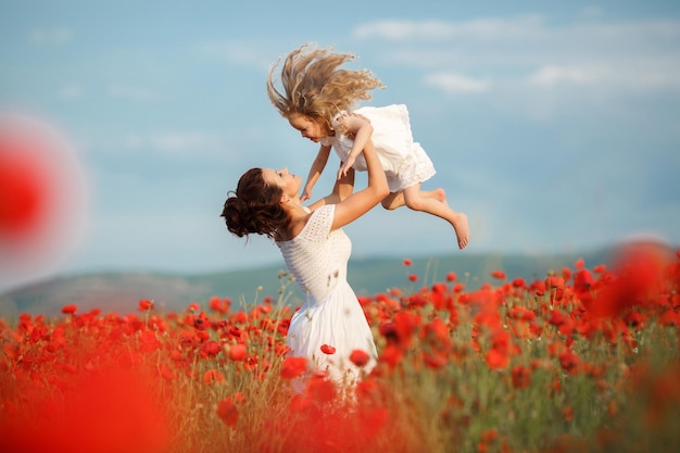 mother and daughter in poppy field