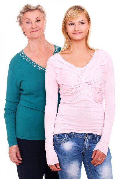 mother and daughter posing on white