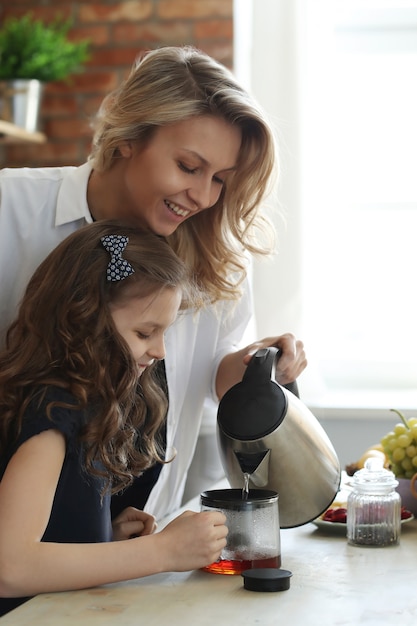 Mother and daughter preparing breakfast