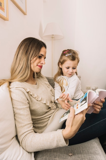 Mother and daughter reading comic book