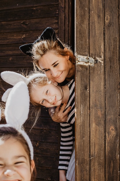 Free Photo mother and daughter behind shed door