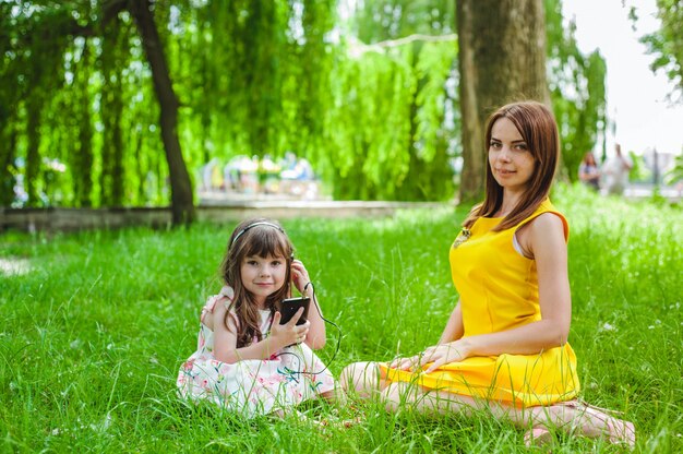 Mother and daughter sitting in a park