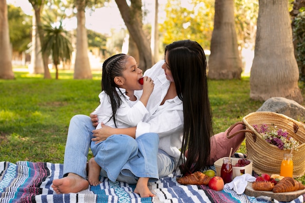 Mother and daughter spending time together outside at the park for mother's day