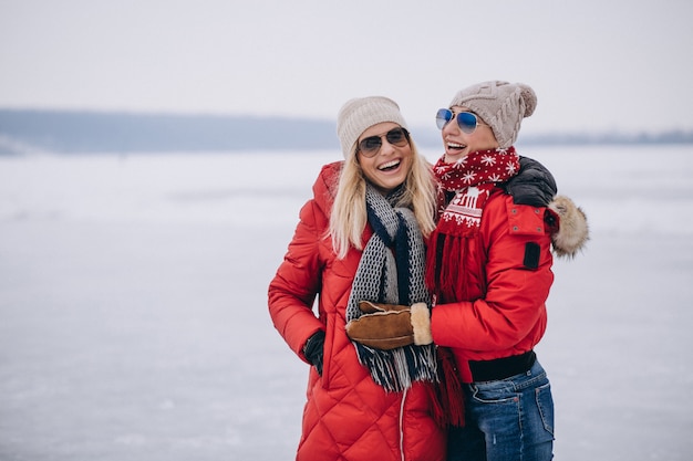 Free Photo mother and daughter together walking in park in winter