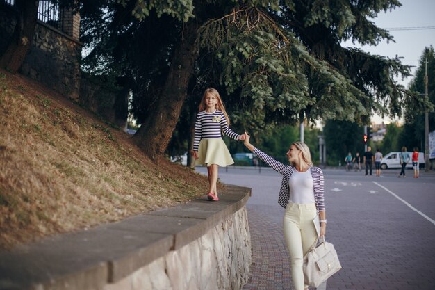 Mother and daughter walking hand in hand