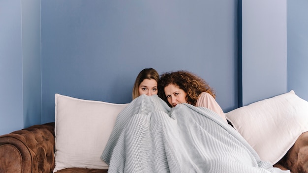 Free photo mother and daughter watching horror movie