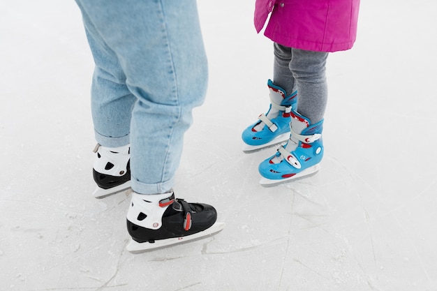 Mother and daughter wearing ice skates