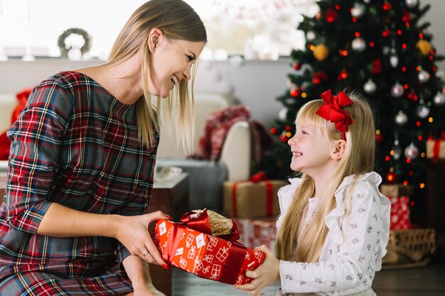 Mother and daughter with present box