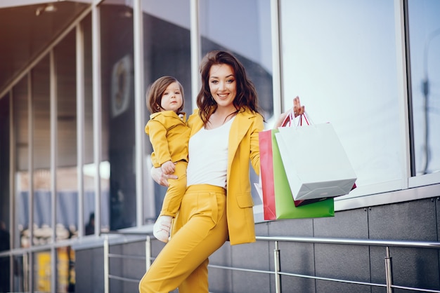 Mother and daughter with shopping bag in a city